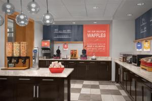 a kitchen with brown cabinets and a red sign on the wall at Hampton Inn & Suites Baltimore North/Timonium, MD in Timonium +31 photos
