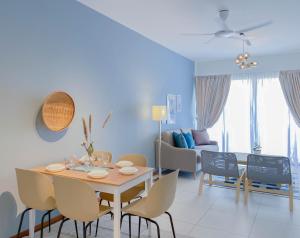 a dining room and living room with a table and chairs at The Landmark By Katana Penang in Tanjong Tokong +25 photos
