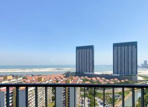 a view of the ocean from a balcony of a building at The Landmark By Katana Penang in Tanjong Tokong