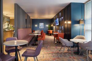 a restaurant with tables and chairs in a room at DoubleTree by Hilton Glasgow Central in Glasgow