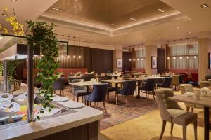a dining room with tables and chairs at DoubleTree by Hilton Glasgow Central in Glasgow