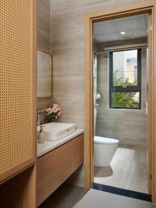 a bathroom with a toilet and a sink and a window at Solla Hotel in Ninh Binh