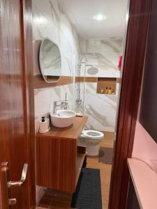 a bathroom with a sink and a toilet at Ndiaghan Hébergement in CambÃ©rÃ¨ne