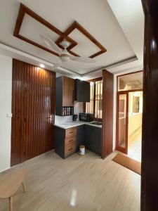 a kitchen with wooden cabinets and a ceiling fan at Ndiaghan Hébergement in CambÃ©rÃ¨ne +19 photos