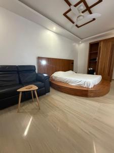 a living room with a bed and a couch at Ndiaghan Hébergement in CambÃ©rÃ¨ne