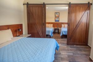 a bedroom with a bed and a sliding door at Hotel Real Capital Tabasco in Villahermosa +13 photos