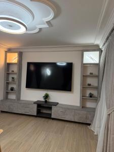 a living room with a flat screen tv on a wall at Ndiaghan Hébergement in CambÃ©rÃ¨ne