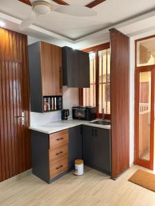 a kitchen with wooden cabinets and a counter top at Ndiaghan Hébergement in CambÃ©rÃ¨ne