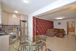 a kitchen with two chairs and a living room at Kaskade House in Yerevan