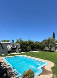 a swimming pool in the yard of a house at La Delfina in Chacras de Coria