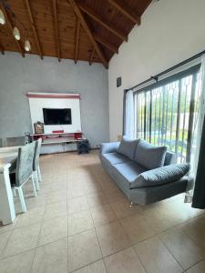 a living room with a couch and a table at La Delfina in Chacras de Coria