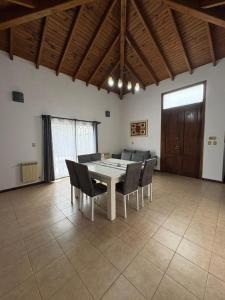 a dining room with a table and chairs at La Delfina in Chacras de Coria