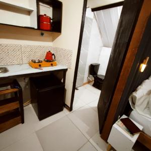 a small kitchen with a toy car on a counter at Chalés & glamping primitivo Búzios in Búzios