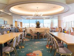 a dining room with wooden tables and chairs at Takarazuka Washington Hotel in Takarazuka