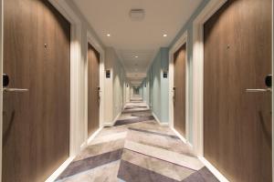 a hallway with wooden doors and tile floors at Hampton By Hilton Edinburgh West End in Edinburgh +23 photos
