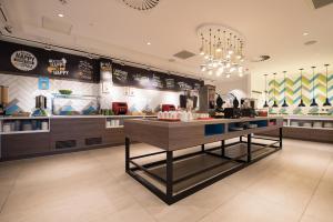 a restaurant with a counter in the middle of a room at Hampton By Hilton Edinburgh West End in Edinburgh