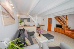 a living room with a couch and a table at Comfortable holiday home, summer pool in Łeba