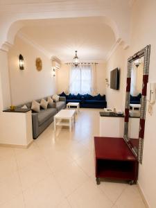 a living room with a couch and a table at Résidence El Harti in Marrakesh