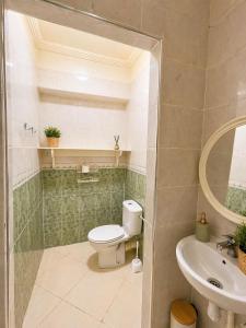 a bathroom with a toilet and a sink at Résidence El Harti in Marrakesh