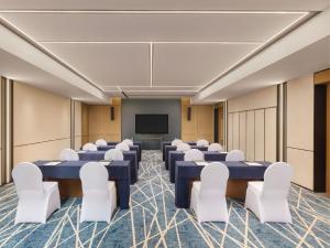 a conference room with blue tables and white chairs at Four Points by Sheraton Jinan, High-Tech Zone in Jinan