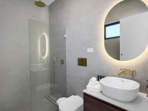 a bathroom with a sink and a mirror at Sereno in Pokolbin +24 photos