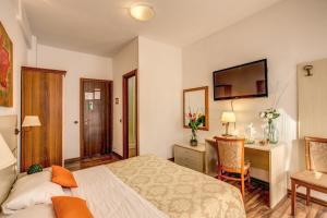 a hotel room with a bed and a desk and chair at Trastevere Rooms in Rome