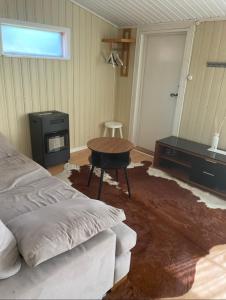 a bedroom with a bed and a table and a desk at Nature & Tranquility in Örebro +4 photos