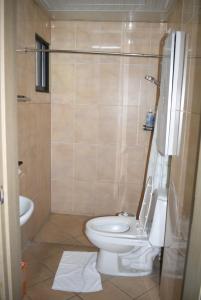a bathroom with a toilet and a sink at Koa Guest House in Angeles