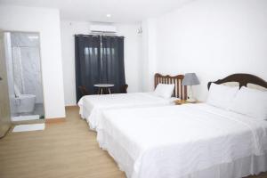 a bedroom with two beds and a window at Koa Guest House in Angeles +3 photos