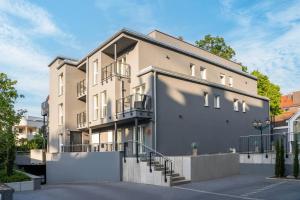 a large building with stairs in a parking lot at Arthotel ANA Eden Karlsruhe, Trademark Collection by Wyndham in Karlsruhe