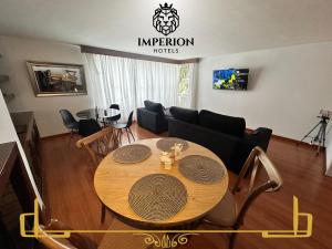 a living room with a table and a couch at Casa Hotel Imperion in Bogotá