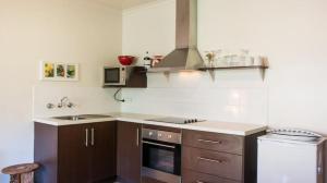 a kitchen with a sink and a stove at Duilius in Robe