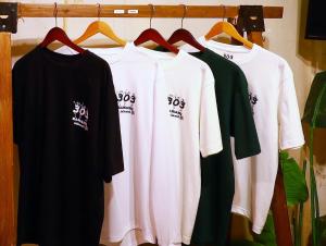 a group of t shirts hanging on a rack at ゲストハウス303 in Zamami +12 photos
