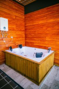 a bath tub in a room with a wooden wall at Montecielo Hosting in Guatapé +285 photos