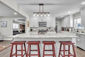 a kitchen with a large island with three bar stools at The Friendship House in Columbus
