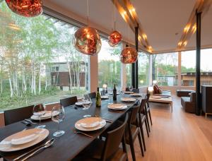 a dining room with a long table and chairs at Yuki Sugi at Intuition in Kutchan