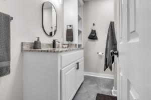 a white bathroom with a sink and a mirror at The Friendship House in Columbus +32 photos
