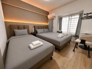 a hotel room with two beds and a chair at Lucky NAMBA 大阪難波 なんば in Osaka +29 photos