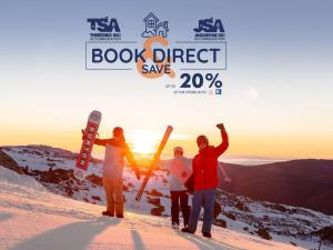 a group of people standing on top of a snow covered mountain at Chalet Nanook Akuna 2 in Thredbo