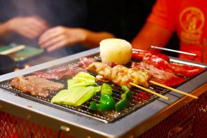 a plate of food with meat and vegetables on a table at ゲストハウス303 in Zamami