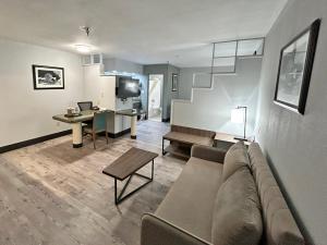 a living room with a couch and a table at SureStay Plus by Best Western Cannon A.F.B. in Clovis