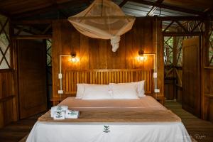 a bedroom with a bed with two towels on it at El Nido in La Macarena