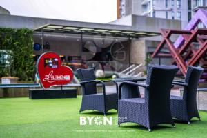 a group of chairs sitting on the grass in a park at Premium Suites D'lement Genting Highlands by BYON in Genting Highlands