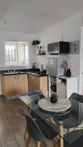 a kitchen with a table and chairs in a room at Comfortable apartment with parking near AIFA in Santa Cruz Tecamac