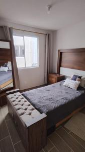 a bedroom with a large bed and a large window at Comfortable apartment with parking near AIFA in Santa Cruz Tecamac
