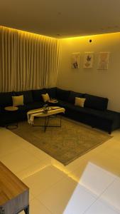 a living room with a couch and a coffee table at العليا in Tabuk