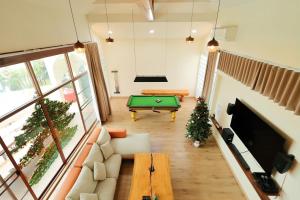 a living room with a pool table in it at Chiang Mai Private "Davin Pool Villa" CNX 2km to Central Festival in Chiang Mai