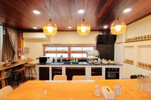 a large kitchen with a table and some lights at Chiang Mai Private "Davin Pool Villa" CNX 2km to Central Festival in Chiang Mai