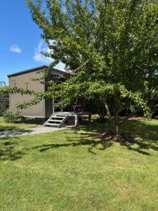 a tree in front of a building with a staircase at 40 Winks in Otorohanga