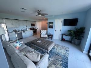 a living room with a couch and a kitchen at Buck island Breeze in Christiansted +3 photos